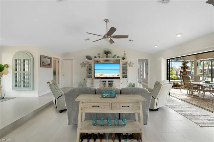 Living room with HD ceiling fan and vaulted ceiling