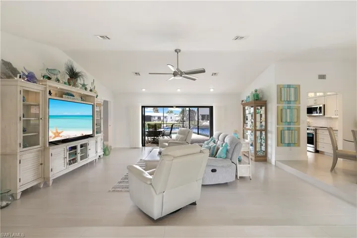 Living room with vaulted ceiling and HD ceiling fan
