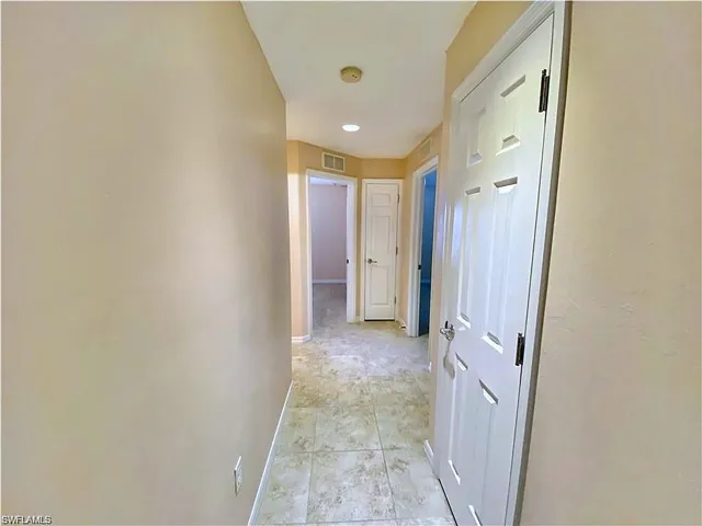 Hallway featuring recessed lighting, ceramic tile flooring, and multiple six-panel interior doors