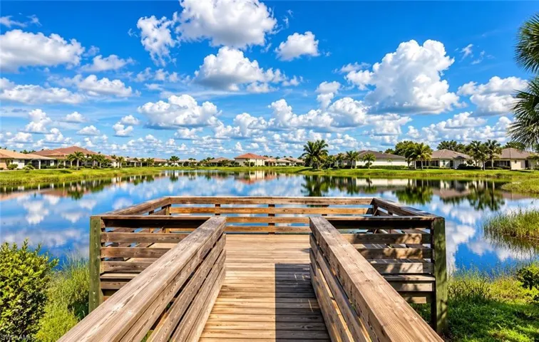 Waterfront Dock & Canal ViewsThis stunning waterfront property features a custom wood-planked dock extending into pristine canal waters, offering direct water access and serene vistas