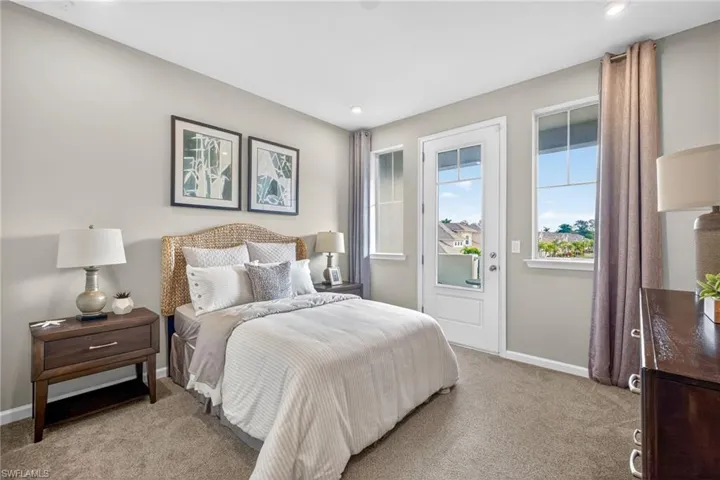 Bedroom with light colored carpet and access to outside