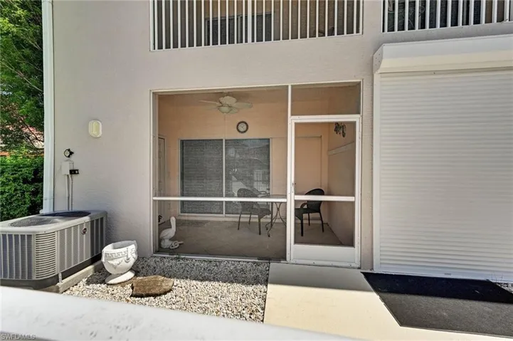 Screened-in patio with concrete flooring, a ceiling fan, and sliding glass door access
