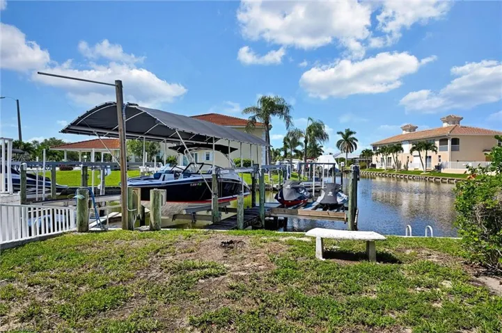 Private dock with boat lift and canopy, offering direct canal access
