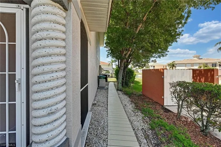 Textured spiral column detailing, with an adjacent screened entry door