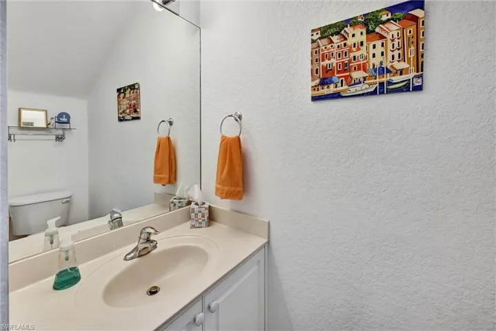 Bathroom vanity with a light-toned countertop and an integrated sink