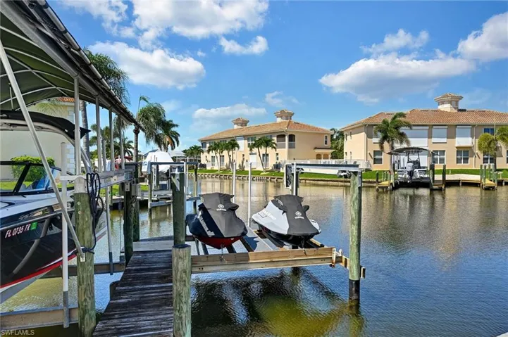 Waterfront property featuring a private boat lift and dock access
