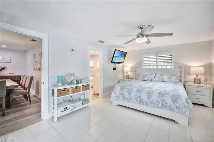 Bedroom with tile patterned floors and ceiling fan