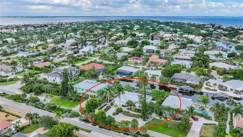 View of property location featuring a nearby body of water and nearby suburban area