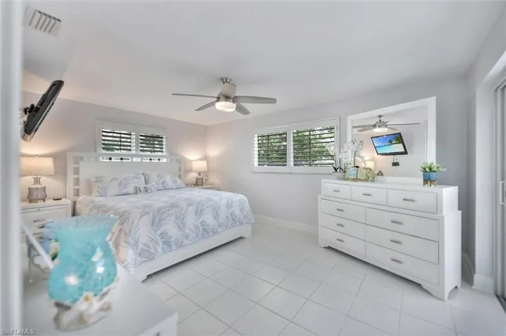 Bedroom featuring light tile patterned floors and ceiling fan