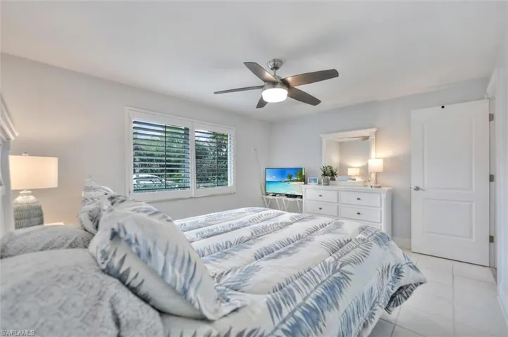 Bedroom featuring light tile patterned floors and a ceiling fan