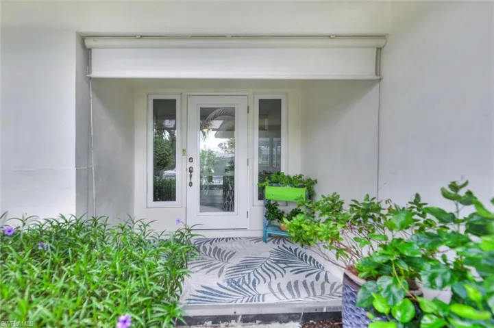 Property entrance featuring stucco siding