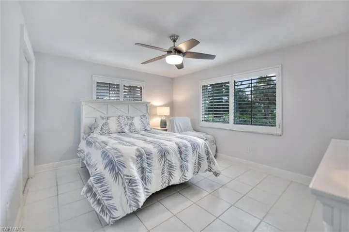 Bedroom featuring light tile patterned floors and a ceiling fan