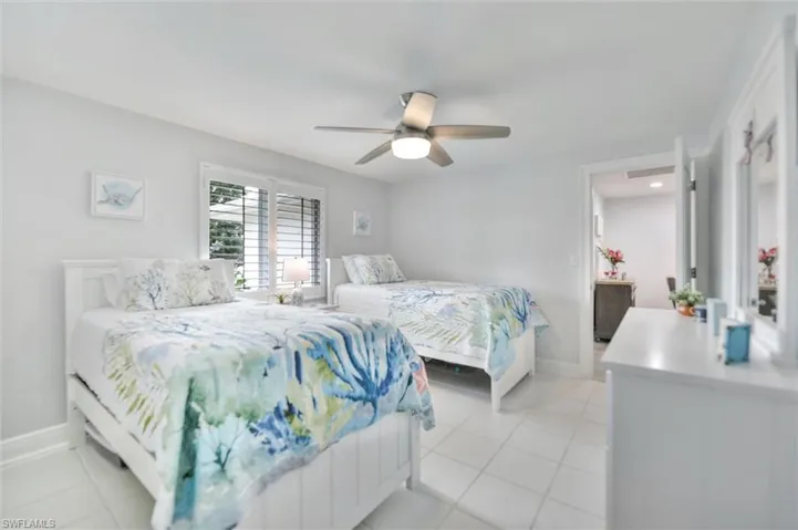 Bedroom featuring light tile patterned floors and ceiling fan