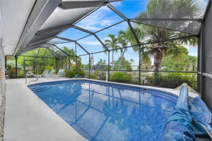 Outdoor pool with a sunroom, a lanai, and a patio area