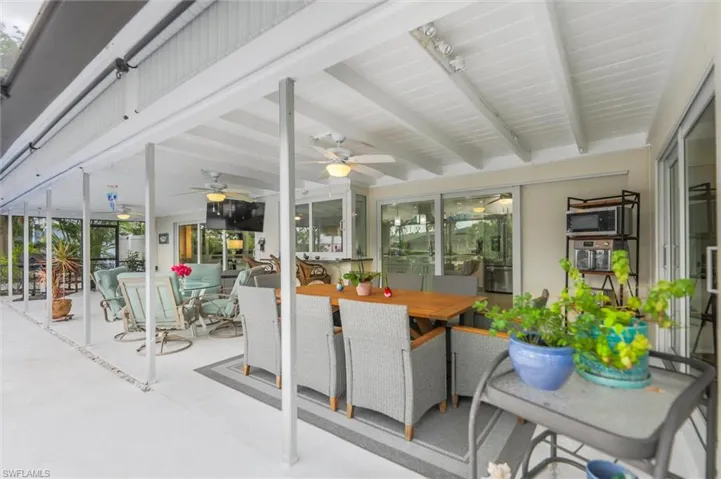 Sunroom / solarium with healthy amount of natural light and beamed ceiling