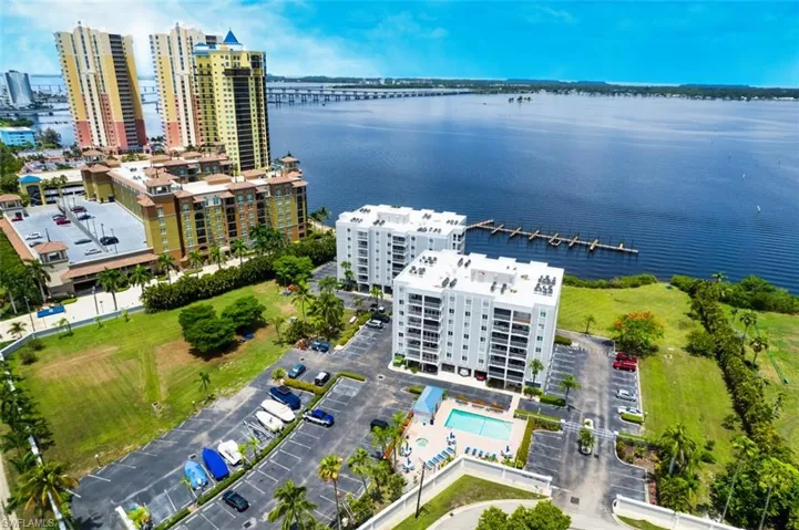 View of urban area with a large body of water and a pool