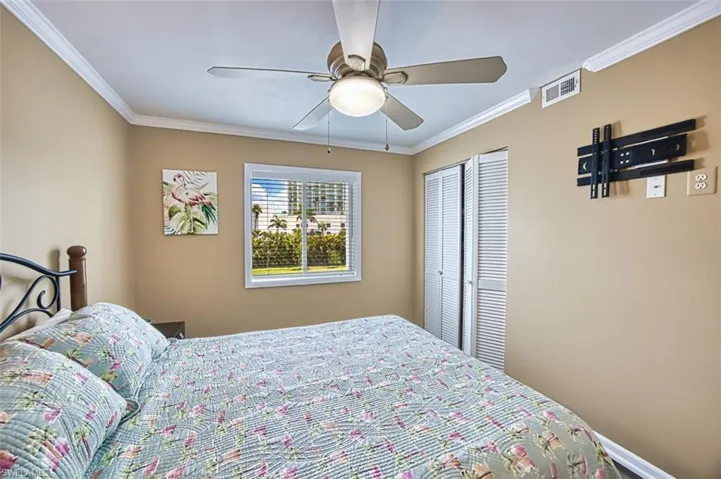 Bedroom featuring ornamental molding, a closet, and ceiling fan
