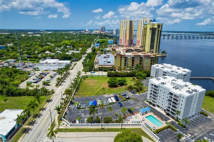View of urban area featuring a nearby body of water and a pool area