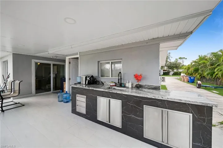 View of patio with exterior kitchen and sink