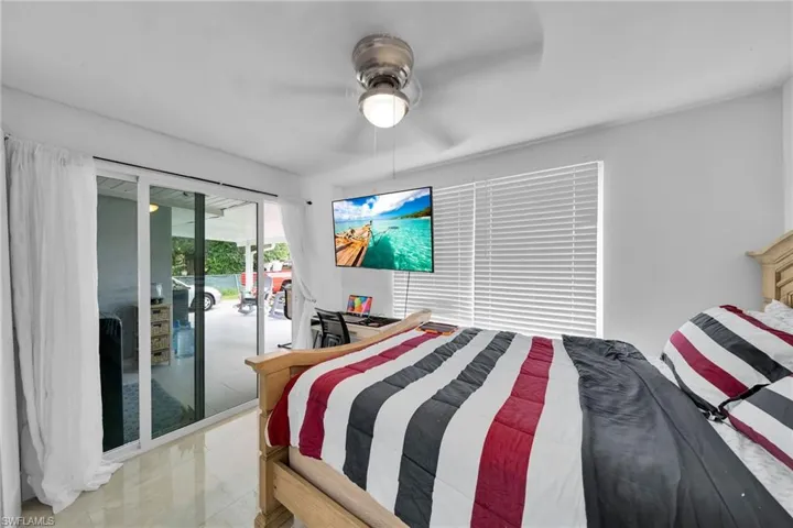 Bedroom featuring french doors, access to outside, and ceiling fan