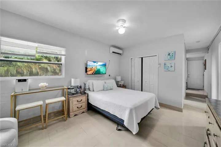 Bedroom with a closet and an AC wall unit
