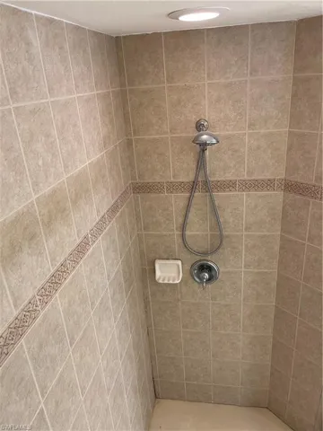 Full bath featuring a tile shower