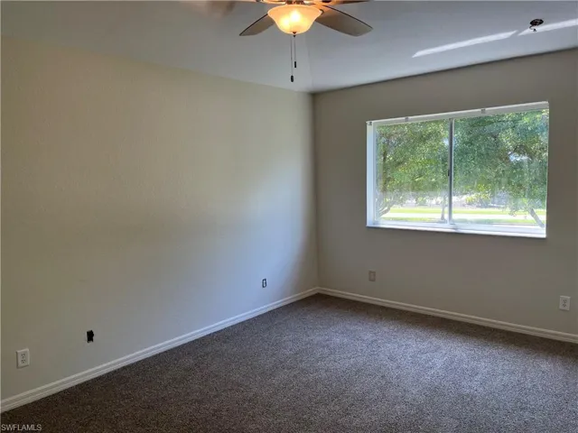 Master room with carpet and a ceiling fan