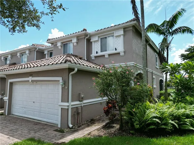 Mediterranean / spanish home featuring stucco siding, an attached garage, and decorative driveway
