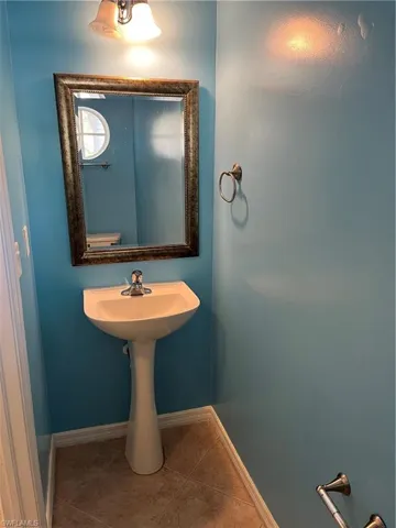 Bathroom featuring tile patterned flooring and baseboards