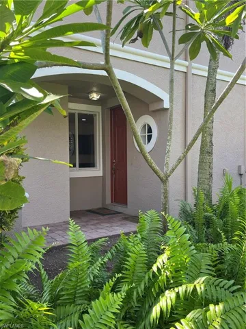 Entrance to property featuring stucco siding
