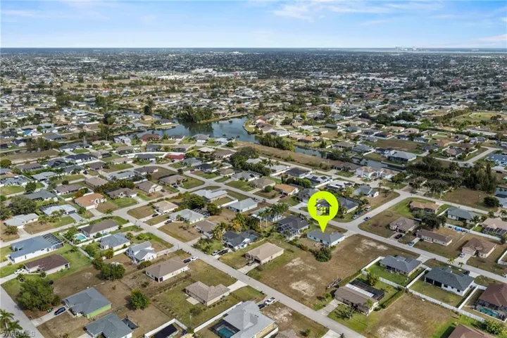 Aerial overview of property's location featuring nearby suburban area and a nearby body of water