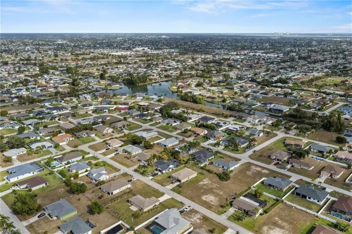 View of property location with nearby suburban area and a nearby body of water