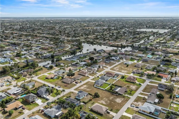 Aerial view of property's location with nearby suburban area and a nearby body of water