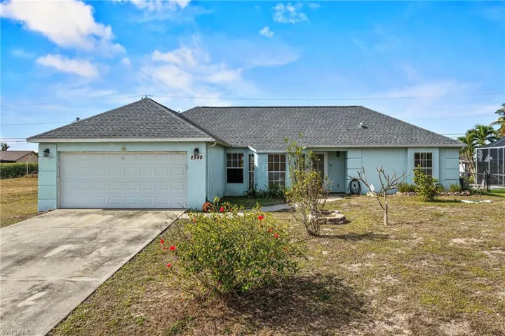 Ranch-style house featuring a shingled roof, stucco siding, driveway, and an attached garage