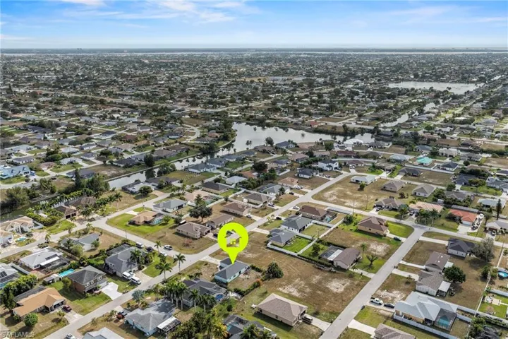 Aerial view of property's location featuring nearby suburban area and a large body of water