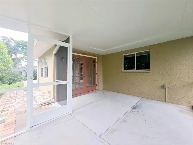 Unfurnished sunroom with french doors