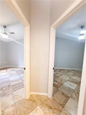 Corridor featuring baseboards
