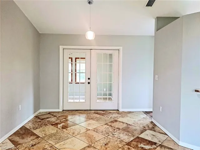 Entryway with french doors and stone finish floors