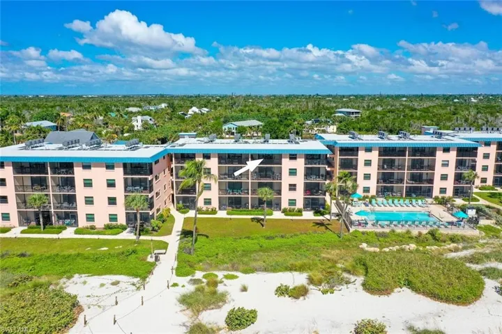 Multi-story building featuring private balconies, a rooftop solar panel system, and exterior swimming pool access
