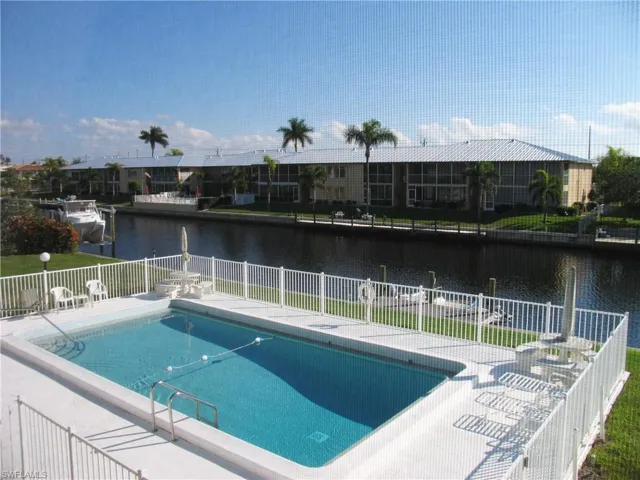View of heated pool, dock and wide Gulf Access canal