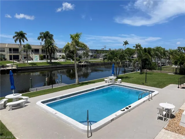 View of heated pool, dock and Gulf Access canal from condo lanai