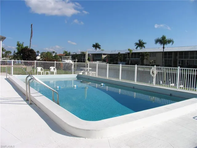 View of heated pool, dock and wide Gulf Access canal