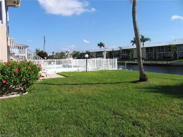 View of heated pool, dock and wide Gulf Access canal and greenspace