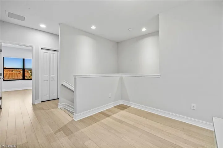 Spare room with recessed lighting and light wood-style flooring