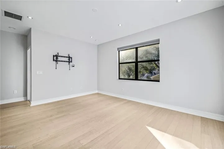 Empty room featuring recessed lighting and light wood-type flooring