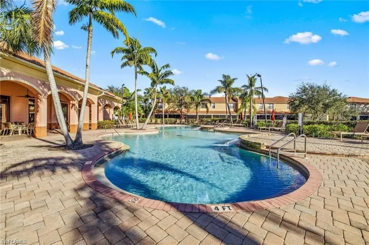 Community pool featuring a patio