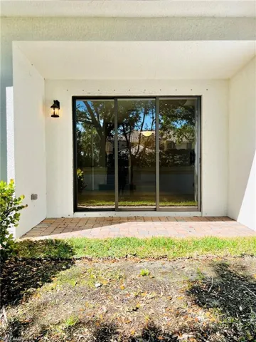 Doorway to property with a patio area