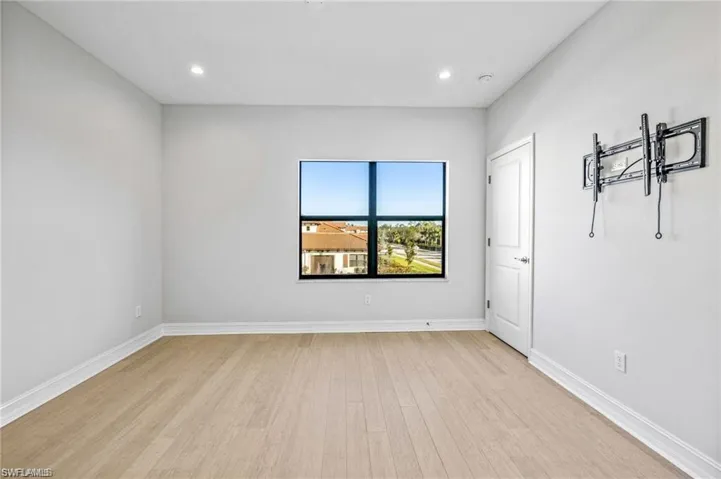 Unfurnished room with light wood-style floors and recessed lighting