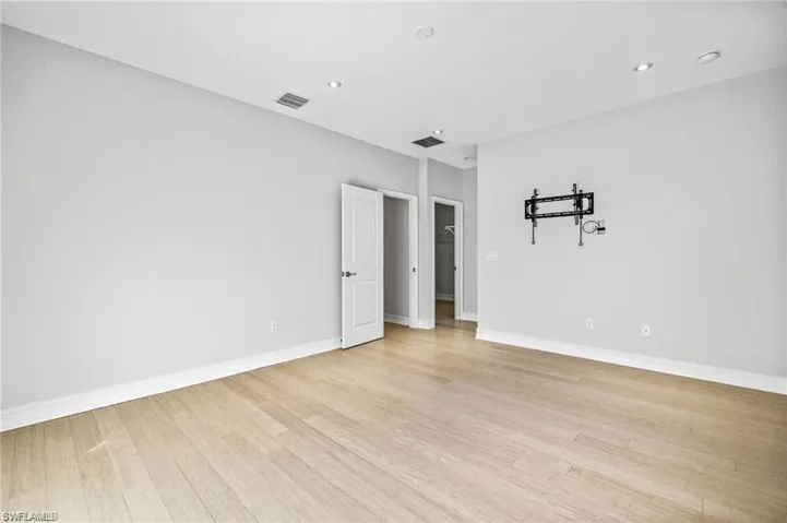Spare room featuring light wood finished floors and recessed lighting
