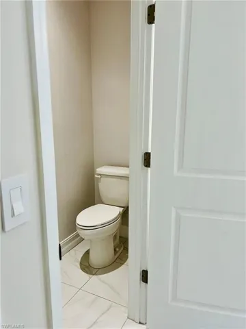 Bathroom featuring toilet and baseboards